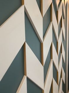 the wall is decorated with white and brown geometric designs on it's sides, along with a light fixture