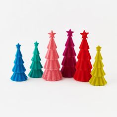 small plastic christmas trees lined up in different colors