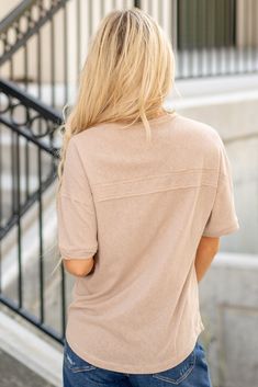 Complete your 90s-inspired wardrobe with this essential twisted sleeve band Henley knit top featuring a round neck and relaxed fit. The drop shoulder design adds a touch of laid-back style, while the button-up front and patch pocket provide a classic and versatile look. This short-sleeve top is perfect for everyday wear and can be easily paired with your favorite bottoms for a casual and cool outfit. The round hem adds a modern twist to this key item for 90's fashion, making it a must-have essen Casual Soft Knit Short Sleeve Tops, Casual Spring Tops With Soft Texture, Casual Spring Top With Soft Texture, Casual Oversized Short Sleeve Knit Top, Beige Soft Knit Crew Neck Top, Casual Soft Texture Top For Spring, Casual Relaxed Fit Knit Top, Casual Loungewear Tops With Soft Texture, Casual Relaxed Fit Knit Top For Everyday