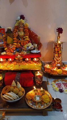 there are many candles and food on the table in front of them, all lit up