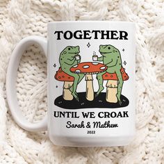 two green frogs sitting at a table together on a white coffee mug with the words, together until we croak