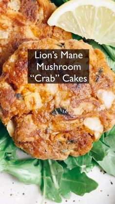 two crab cakes with lemon wedges and spinach leaves on the side that says lion's mane mushroom crab cakes