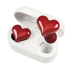 two red heart shaped earbuds sitting in an open case on a white surface