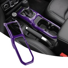 the interior of a car with purple trims and steering wheel center console, pedal covers and cup holders