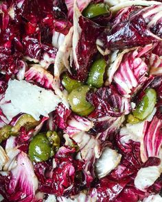 a salad with red cabbage, green beans and parmesan cheese is shown in a bowl