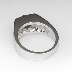 This attractive wide band diamond ring is centered with one (1) round brilliant cut diamond that is bezel seat and weighs approximately 0.30 carats. Accenting the top of the ring are eight (8) channel/ bead set round brilliant cut diamonds. Each shoulder of the ring is accented with two-rows of four (4) channel set round brilliant cut diamonds. The ring measures 7.8mm at the top, rises 6.8mm above the finger, tapering to 3.9mm wide and 1.4mm thick at the base of the shank. It is currently a size 5.25. Bezel Diamond Ring, Wide Band Diamond Rings, Bezel Diamond Rings, Band Diamond Ring, Bead Set, Channel Set, Bezel Diamond, Wide Bands, Round Brilliant Cut Diamond