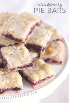 a white plate topped with blueberry pie bars