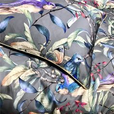 an image of a bird on a tree branch printed bedding set with blue and green leaves