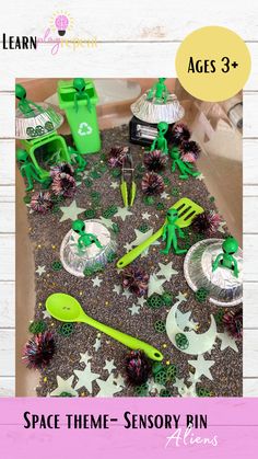 an open box with green toys on it and the words space theme - sensory bin