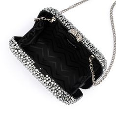 With its curved lines and glossy hardware, Olga Berg's Casey Hot Fix Encrusted Clutch is a total show stopper. The rounded square shape fits comfortably in the palm of your hand. Wear it as a shoulder bag or wear it as a clutch by tucking the shoulder chain inside. W18cm x H12cm x D6cm Shoulder chain drop length 50cm Encrusted block lock closure Removable shoulder chain Fits a smart phone Luxury Evening Clutch With Silver-tone Hardware, Luxury Silver Clutch For Evening, Sparkling Evening Clutch Bag, Luxury Silver Rectangular Evening Bag, Glamorous Glitter Rectangular Evening Bag, Glamorous Clutch Evening Bag With Silver-tone Hardware, Rectangular Evening Clutch With Silver-tone Hardware, Evening Clutch With Silver-tone Hardware, Glamorous Silver-tone Clutch Evening Bag