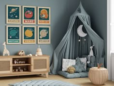 a child's room with blue walls and pictures on the wall, including an animal bed