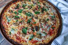 a pizza sitting on top of a pan covered in cheese and toppings