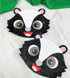 two paper plates with black and white animals on them