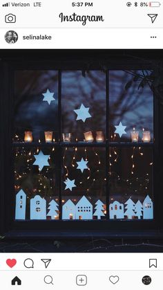 an instagram photo with candles in the window and stars on the windowsills