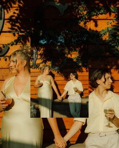 two people standing next to each other in front of a wooden wall and holding drinks