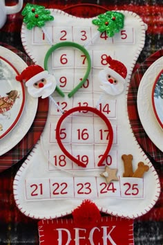 a christmas themed table setting with santa's stocking and reindeers on it