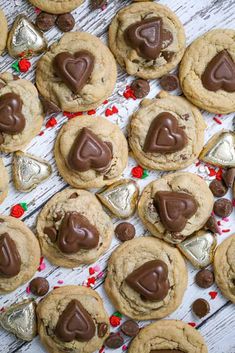 chocolate chip cookies with hearts and candy canes on a white wooden surface, surrounded by confetti