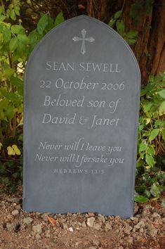 a grave marker in the ground near some bushes and trees with leaves around it that reads, 22 october 2006 beloved son of david & janer never will leave you never