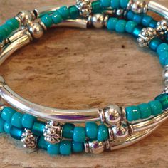 "This Stunning Bohemian Style Bracelet will be noticed and adored! It's made to wrap around your wrist three times and connects with a lobster clasp. It has an extension chain to adjust to a tight or loose fit. Beautiful, high quality turquoise glass Czech seed beads, silver tube beads and Silver Tibetan beads are through out. This bracelet can be worn in every season, dressed up or down! This stunning bracelet can also be worn as a beautiful and unique necklace! You can choose your own symbolic Bohemian Turquoise Beaded Bracelets With Silver Beads, Bohemian Turquoise Beaded Bracelet With Silver Beads, Turquoise Beaded Bracelets With Silver Beads, Adjustable Turquoise Stretch Bracelet With Silver Beads, Turquoise Stretch Bracelet With Silver Beads, Bead Wrap Bracelet, Black Turquoise, Beaded Wrap Bracelets, Turquoise Glass