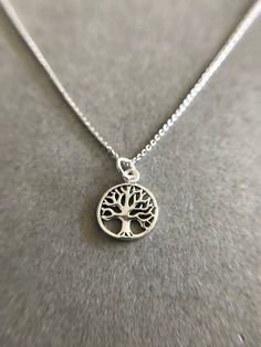 "Tiny Mini Tree of Life Silver Necklace - Sterling Silver Color : Silver Material : Sterling Silver Tree of Life Size : 12mm Chain Length : 16\" / 18\" / 20\" * Metal components are Sterling Silver. * Suitable for delicate and sensitive skin. * Comes in a jewelry box. If you need extra boxes for gifting....just let us know! Less" Silver Round Charm Necklace 16 Inch, Sterling Silver Tree Of Life Jewelry, Symbolic Tree Of Life Sterling Silver Jewelry, Silver Tree Of Life Necklace For Healing, Tree Of Life Necklace Silver, Sterling Silver Tree Of Life Necklace With Round Pendant, Bee Studs, Tiny Hoop Earrings, Hamsa Necklace