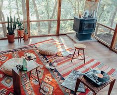 a living room filled with furniture and a fire place next to a large glass window