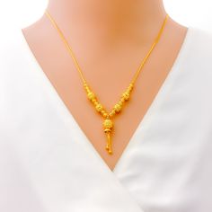 This ethereal 22k gold necklace exudes a lovely charm, perfect for adding a touch of elegance to any ensemble. Weighing 8.9 grams, it offers a luxurious yet comfortable feel. The radiant yellow gold finish enhances its timeless beauty. With a necklace length of 18.5 inches and a drop length of 1 inch, this piece is designed to gracefully complement your neckline. The secure lobster lock ensures comfortable and confident wear. Elevate your jewelry collection with this exquisitely crafted necklace Elegant 22k Gold Temple Necklace In Yellow, Elegant 22k Gold Yellow Temple Necklace, Elegant Yellow 22k Gold Temple Necklace, Yellow 22k Gold Pendant Necklace, Elegant Gold Plated Yellow Temple Necklace, Elegant 22k Gold Yellow Chain Necklace, 22k Gold Necklace, Bridal Jewelry Necklace, Precious Stones Rings