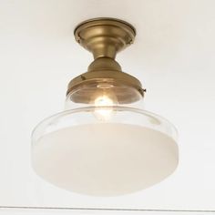 a close up of a light fixture on a ceiling in a room with white walls