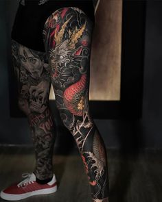 a person with tattoos on their legs and leg