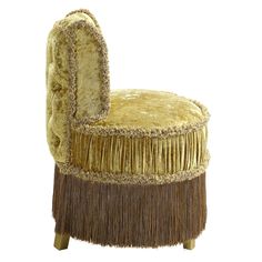 an upholstered chair with fringes on it