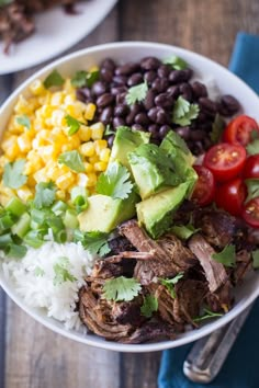 two white bowls filled with meat, rice and veggies on top of a wooden table