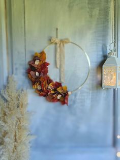 a wreath is hanging on the wall next to a candle