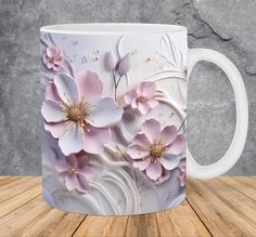 a white coffee mug with pink flowers on it