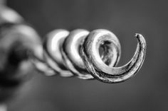 a close up view of a rope with metal rings on it's end, in black and white