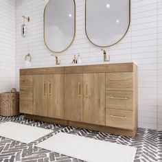 a bathroom with two sinks and mirrors on the wall next to a rug in front of it