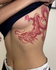 a woman with a dragon tattoo on her stomach