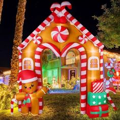 an inflatable gingerbread house is decorated with candy canes and christmas lights