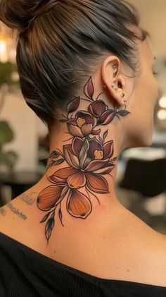 a woman with a flower tattoo on her neck