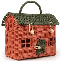 a wicker basket with a house on the front and two small windows in the back