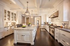 a large kitchen with an island in the middle and lots of cabinets on both sides