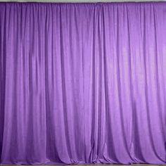 a purple curtain in front of a white wall