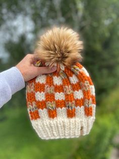 Ready To Ship! Adult sized Classic Cozy Buffalo Plaid Beanie.  Colors are from Lion Brand Yarn called Fisherman (brim), Pumpkin & Coney Island, all super bulky yarns.  They blend nicely together to create this beautiful Buffalo Check.  Luxurious Faux Fur Pom is called Toasted Marshmallow. These are very warm for the cold winter days.  The yarn is 20% wool, 80% acrylic.  Fits head circumference from 19-23" so will fit teen to adult sized head.  Made in a smoke-free home.     Spot clean only! Pattern by Me! You can find this pattern here if you'd like to purchase it: https://www.etsy.com/listing/923495930/cozy-buffalo-plaid-beanie-knitting Chunky Knit Beanie For Fall, Acrylic Beanie For Fall, Knit Beanie For Fall, One Size Fits Most, Fall Acrylic Hand Knitted Beanie, Brown Knitted Beanie For Fall, Cozy Knit Hat For Fall Season, Cozy Knitted Hats For Fall, Cozy Knit Hat For Fall, Cozy White Beanie For Fall