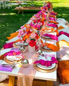 a long table is set with plates and place settings