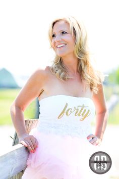 a woman in a pink and white dress posing for a photo