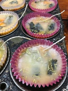 several muffin tins filled with food on top of a stove burner covered in ice