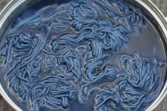 a metal pan filled with blue stuff on top of a table