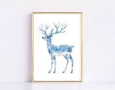 a blue and white deer print in a gold frame