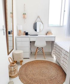 a bedroom with white furniture and natural accessories