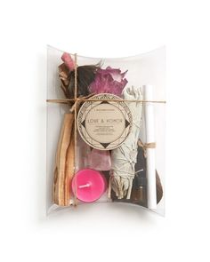 an assortment of candles and soaps in a clear package on a white background,