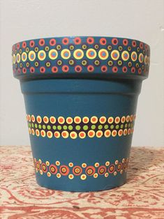 a blue flower pot sitting on top of a table