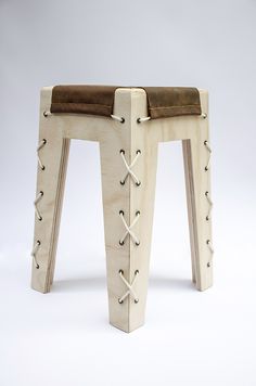 a stool made out of wood and leather